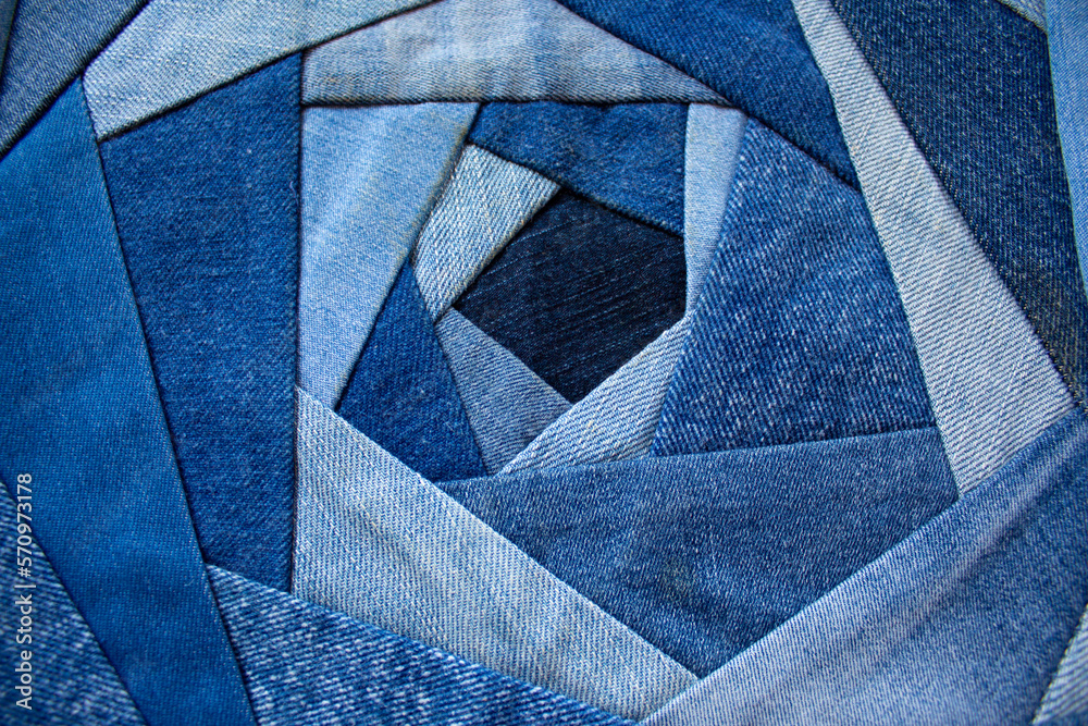 Jeans background, patchwork texture. The new life of old jeans. Recycling old clothes. Denim quilt for a pillow in the crazy-rose technique - obrazy, fototapety, plakaty 