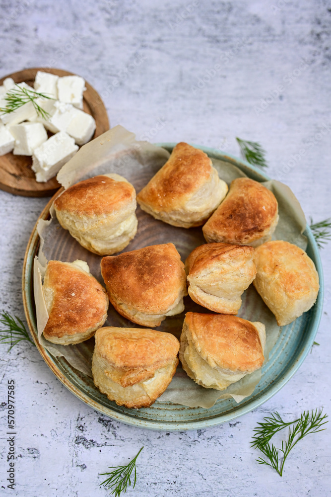 Fresh baked home made Mini cheese puff pastries and cream spread cheese.Cheese pie with phyllo pastry and herbs Fresh baked home made Mini cheese puff pastries and cream spread cheese.Cheese pie with phyllo pastry and herbs