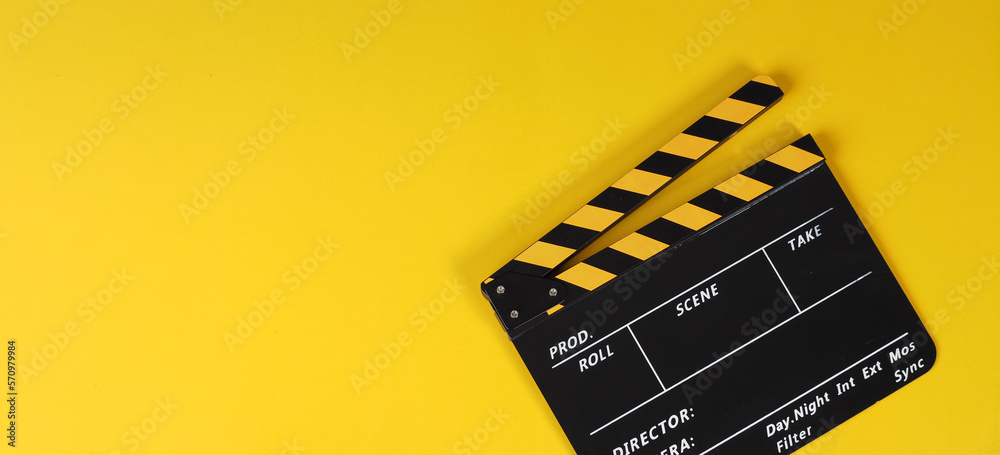 Clapper board or yellow movie slate on yellow background..