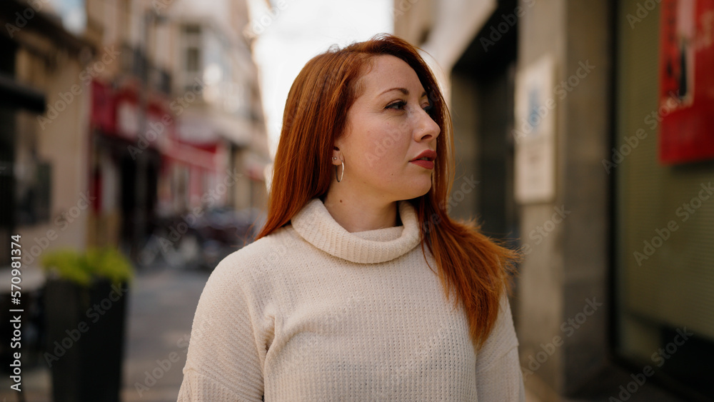 Young redhead woman smiling confident standing at street