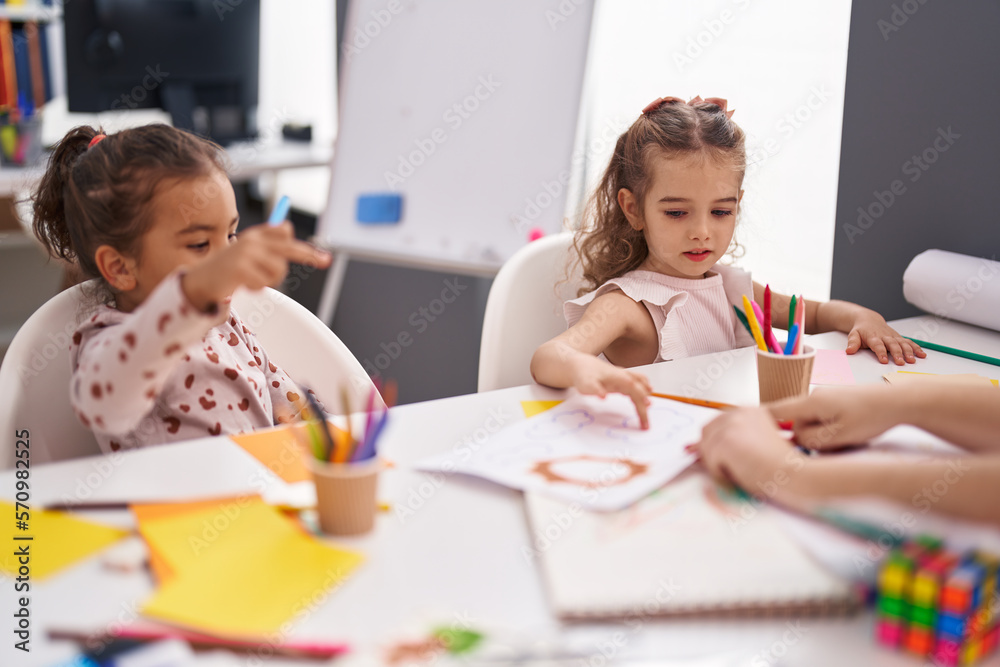 Two kids preschool students having lesson with teacher at classroom Two kids preschool students having lesson with teacher at classroom