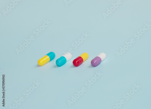 Pharmaceutical medicine pills, tablets and capsules on blue background. Top view. Flat lay. Copy space. Medicine concepts.