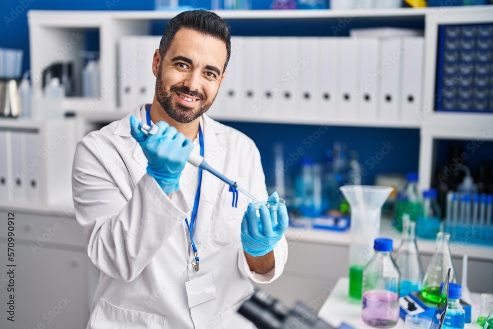 Young hispanic man scientist smiling confident working at laboratory Young hispanic man scientist smiling confident working at laboratory