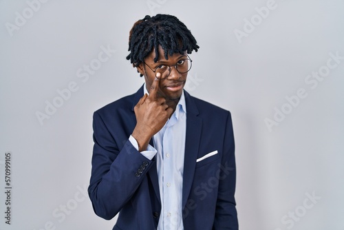 Photos Young african man with dreadlocks wearing business jacket over white background