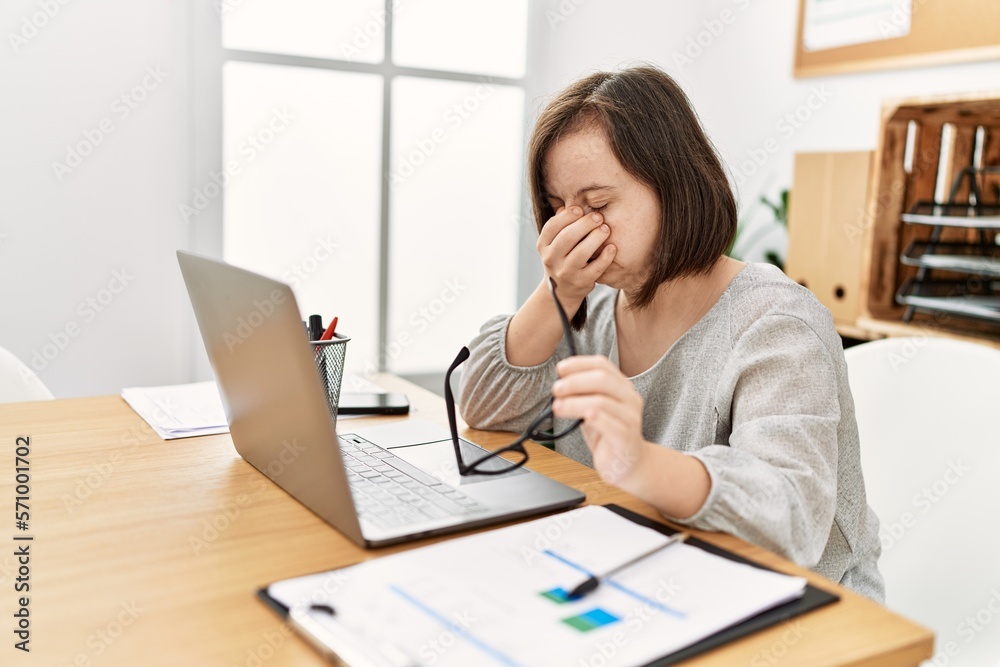 Brunette woman with down syndrome working tired at business office Brunette woman with down syndrome working tired at business office