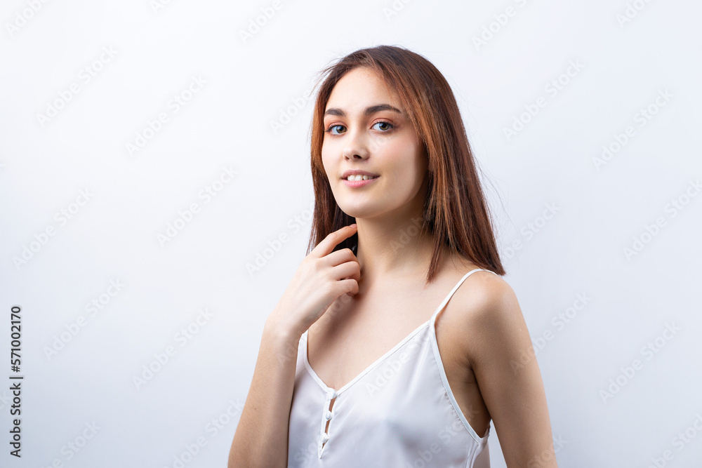 Fototapeta premium Beautiful smiling woman with clean skin, natural make-up and white teeth on a gray background