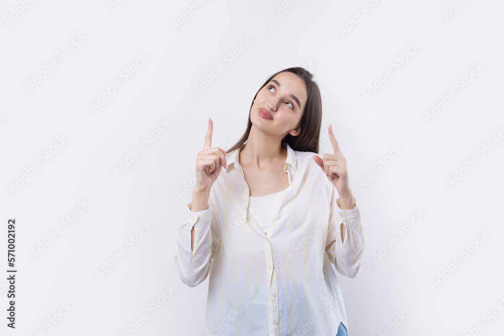 Happy young caucasian female in a shirt pointing fingers away Happy young caucasian female in a shirt pointing fingers away