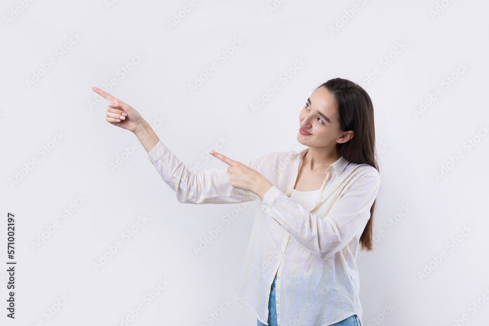 Happy young caucasian female in a shirt pointing fingers away Happy young caucasian female in a shirt pointing fingers away