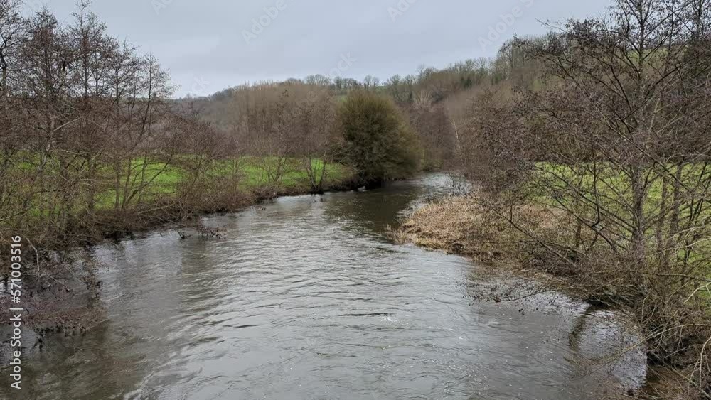 Forest meandering river flows. Rural natural area with hills and forests. Forest meandering river flows. Rural natural area with hills and forests.