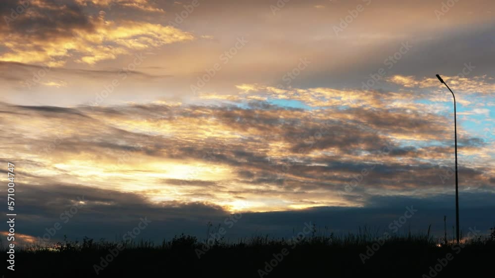 Trucks and cars driving along the highway at high speed. Sky bright red clouds Trucks and cars driving along the highway at high speed. Sky bright red clouds