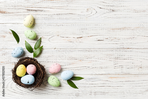 Photography Colorful easter eggs in nest on table background with copy space top view