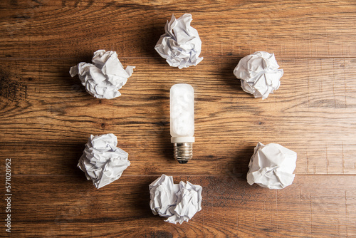 Light bulb and crumpled papers