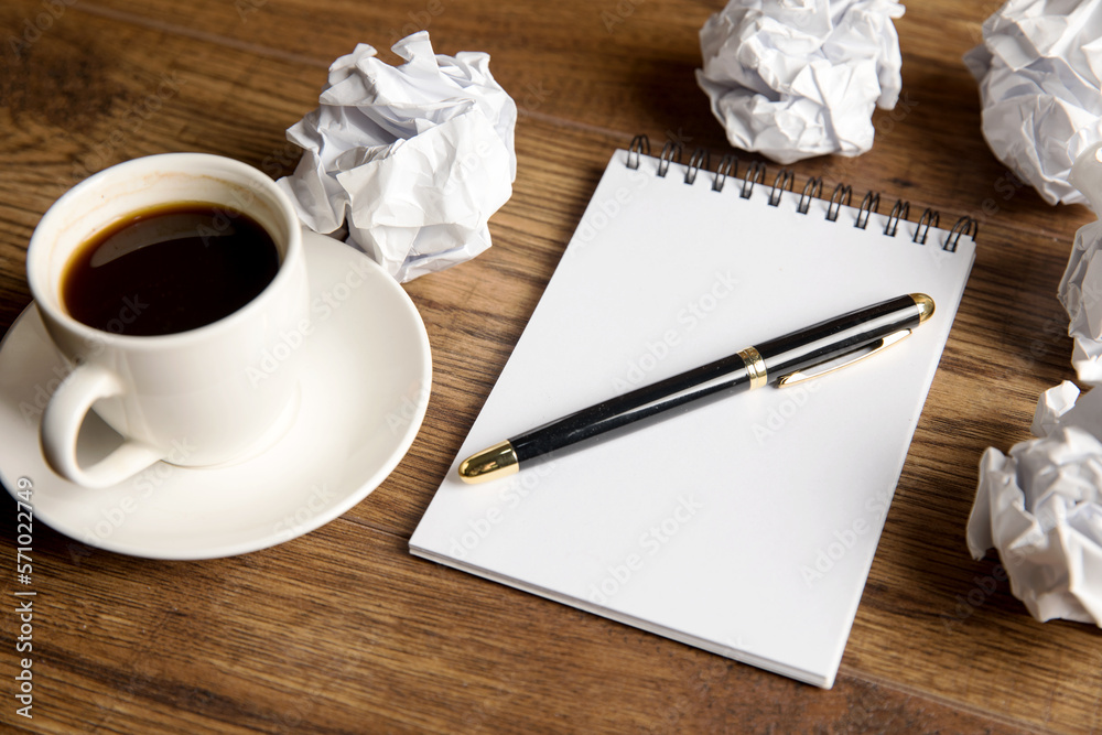Notepad, cup of coffee and crumpled papers Notepad, cup of coffee and crumpled papers