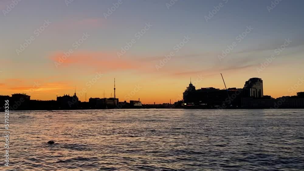 Sunset view of silhouettes of buildings across Neva river in Saint Petersburg Sunset view of silhouettes of buildings across Neva river in Saint Petersburg