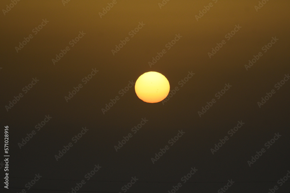 The sun at dawn through the mist The sun at dawn through the mist