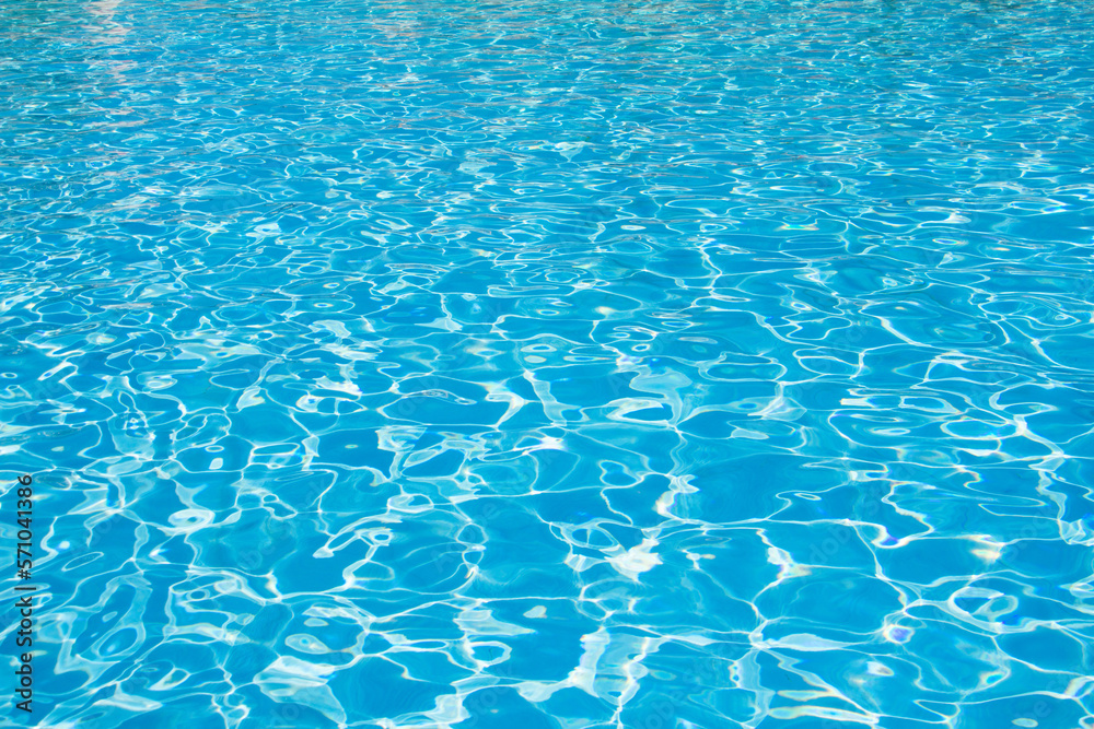 Pure blue water background. Outdoor swimming pool