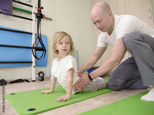 girl on physiotherapy in a children therapy center. Kid doing exercises training with physiotherapists. prevention and treatment of scoliosis 