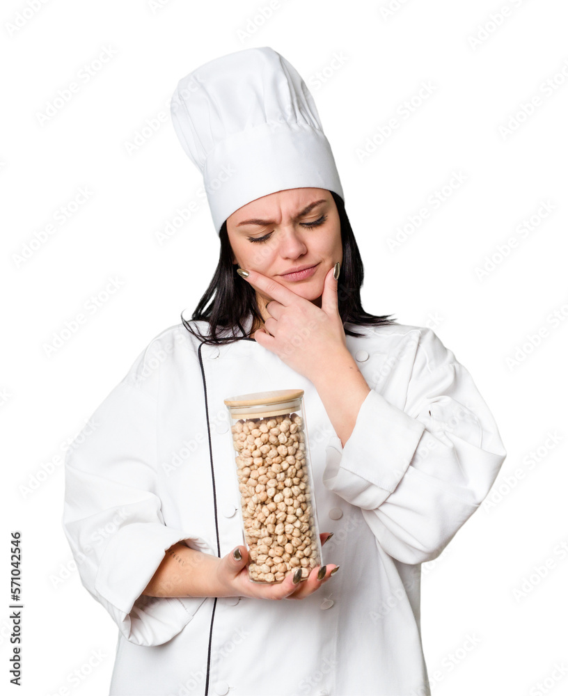 Young cook woman holding chickpeas isolated Young cook woman holding chickpeas isolated