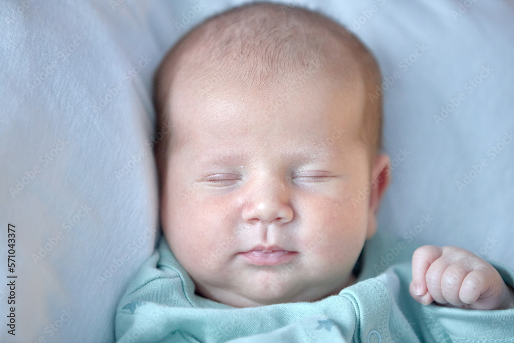 the newborn boy is sleeping. cute beautiful baby is sleeping closeup portrait of a beautiful sleeping baby on white. the newborn boy is sleeping. cute beautiful baby is sleeping closeup portrait of a beautiful sleeping baby on white.