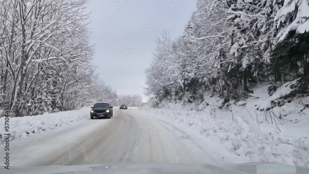 winter snow-covered road in a mountain forest. shooting through the windshield. winter snow-covered road in a mountain forest. shooting through the windshield.