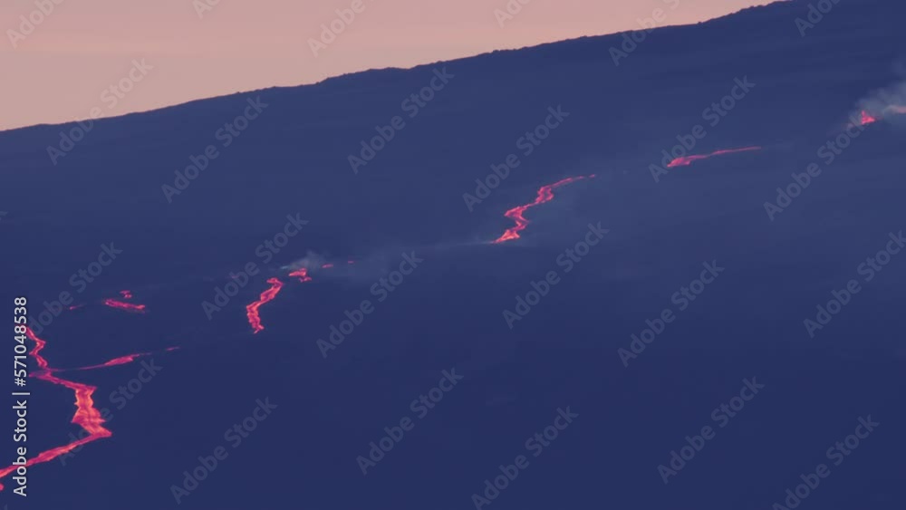 Panorama on RED camera Mauna Loa mountain eruption with hot red lava flow seen above clouds moving fast on foreground, Hawaii Big island in Pacific ocean. Outdoor nature wanderlust adventure tourism