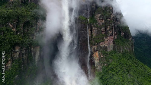 Aerial view of beautiful Angel Falls waterfall through the clouds. A huge flow of water falls from the mountain. The tallest uninterrupted waterfall in the world. Canaima National Park, Venezuela