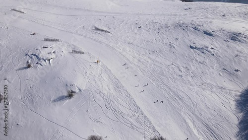 Skier on the ski slope piste downhill skiing in winter day on snow in Old Mountain Stara planina Babin Zub resort tourist destination drone aerial view photo