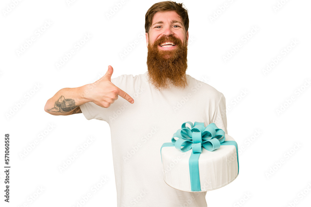 Fotografija Adult man holding a sweet cake recently made isolated cut out person pointing by