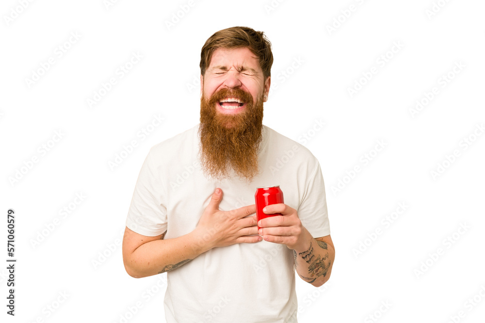 Young adult long beard man drinking a cola isolated laughing and having fun. Young adult long beard man drinking a cola isolated laughing and having fun.