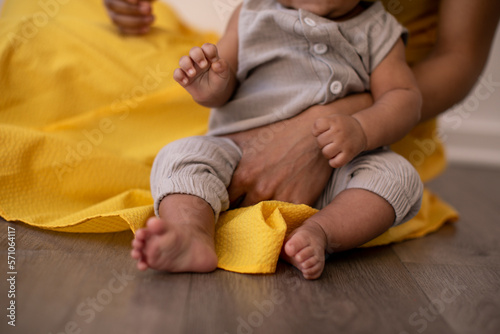 black mom yellow dress holding black baby