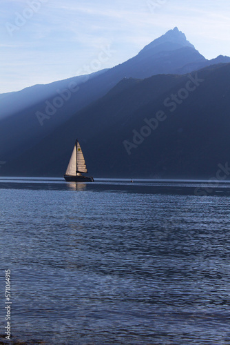 Sail boat on lake Bourget with Dent du Chat mont peak Auvergne-Rhône-Alpes region France	