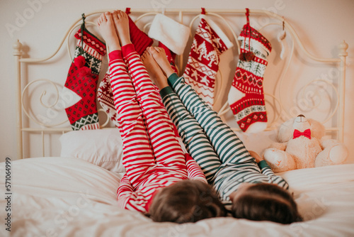 christmas stockings and kids feet on the bed
