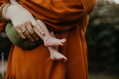 mother holding baby toes
