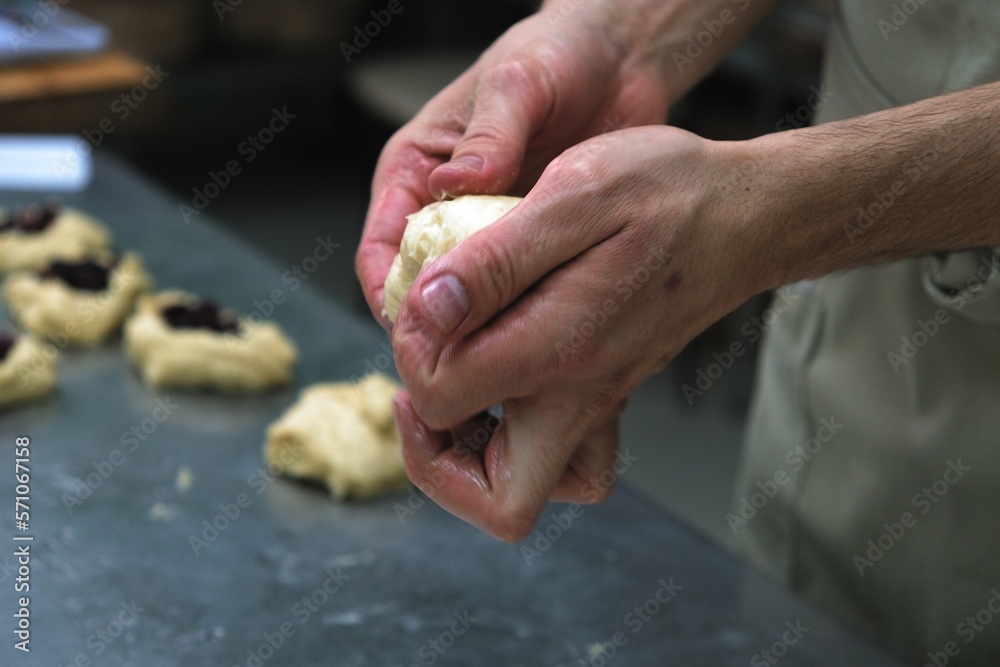 baker at work. The baker shapes the bread. Hands on the close-up form bread baker at work. The baker shapes the bread. Hands on the close-up form bread