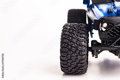 Close-up of a wheel with an off-road tread on a white background. Space for text.