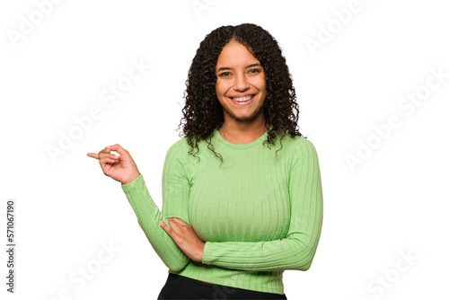 Young african american curly woman isolated smiling cheerfully pointing with forefinger away.
