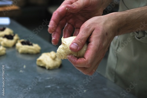 baker at work. The baker shapes the bread. Hands on the close-up form bread