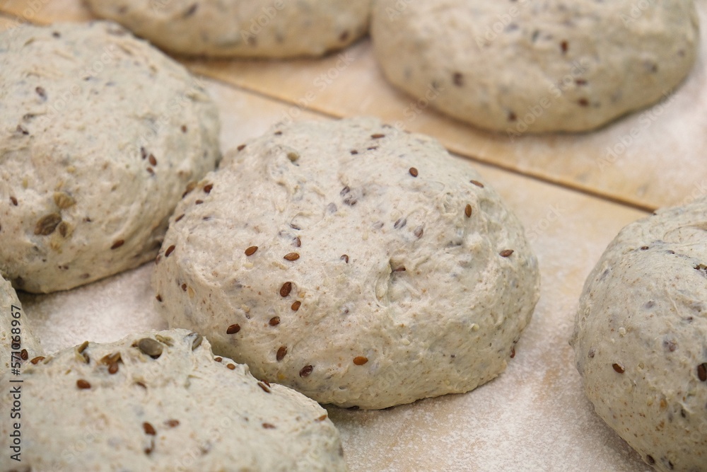preparations of grain bread are on the table. baker at work. The baker shapes the bread. Hands on the close-up foruyut bread preparations of grain bread are on the table. baker at work. The baker shapes the bread. Hands on the close-up foruyut bread
