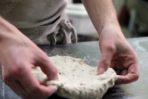 baker at work. The baker shapes the bread. Hands on the close-up form bread