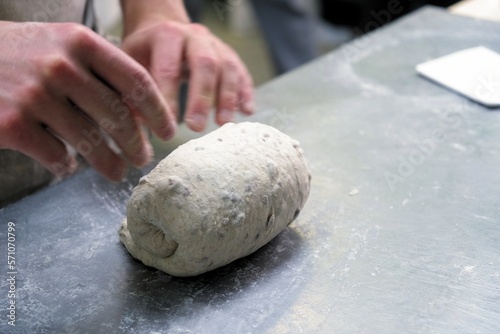 baker at work. The baker shapes the bread. Hands on the close-up form bread