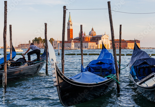 Panoramic view of gondolas at sunset, traditional on Grand Canal with San Giorgio Maggiore church. San Marco, Venice, Italy