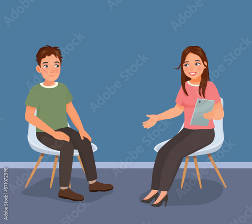 Young man having psychotherapy counseling session with female psychotherapist in the office
