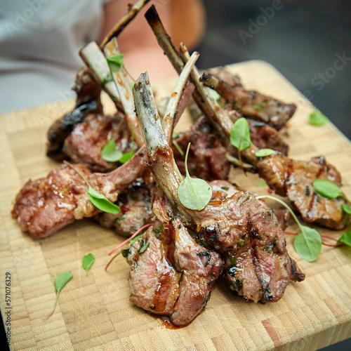 Lamb Chops with Microgreens on a Wooden Serving Board