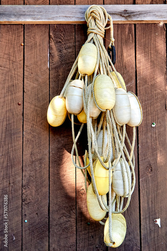 White Swimming Buoys Hanging on a Wooden Wall