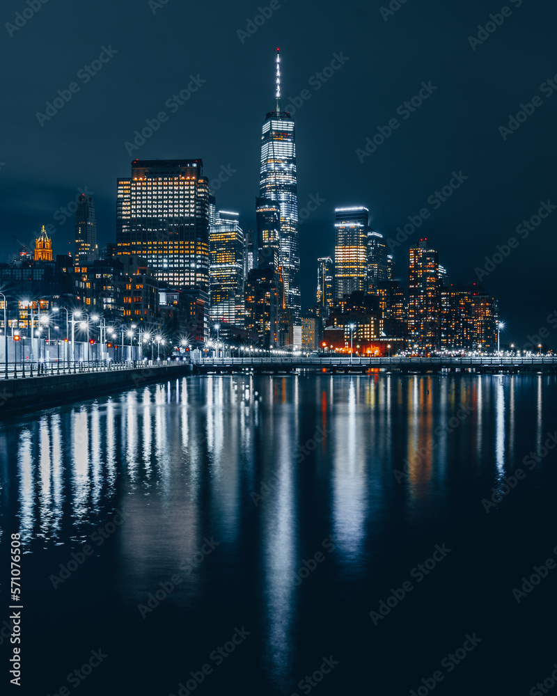 NYC downtown skyline at night reflected in water