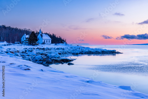Charlevoix, sunrise over the chapel of Port-au-Persil, typical landscape of this region between hills and river. photo