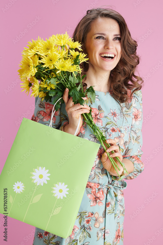smiling elegant woman in floral dress on pink smiling elegant woman in floral dress on pink