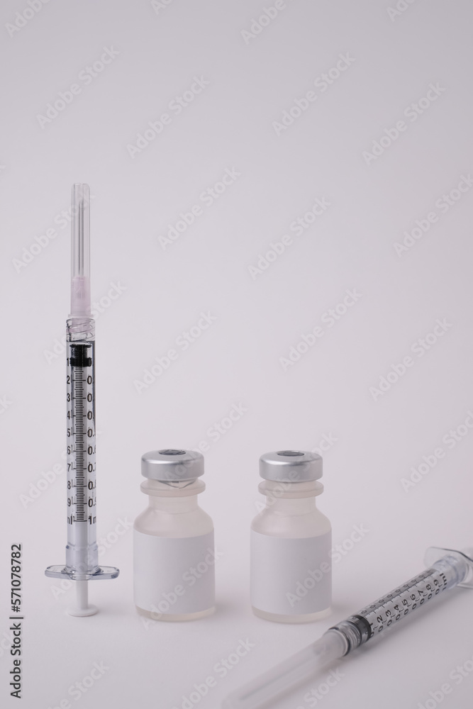 the needle and syringe with the vaccine vial for injection and pharmacy