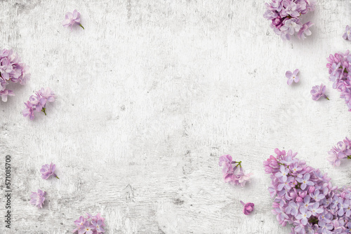 romantic floral composition with loosely arranged lilac flowers on a rustic white wooden background, spring, gardening or Mother's Day concept, top view / flat lay