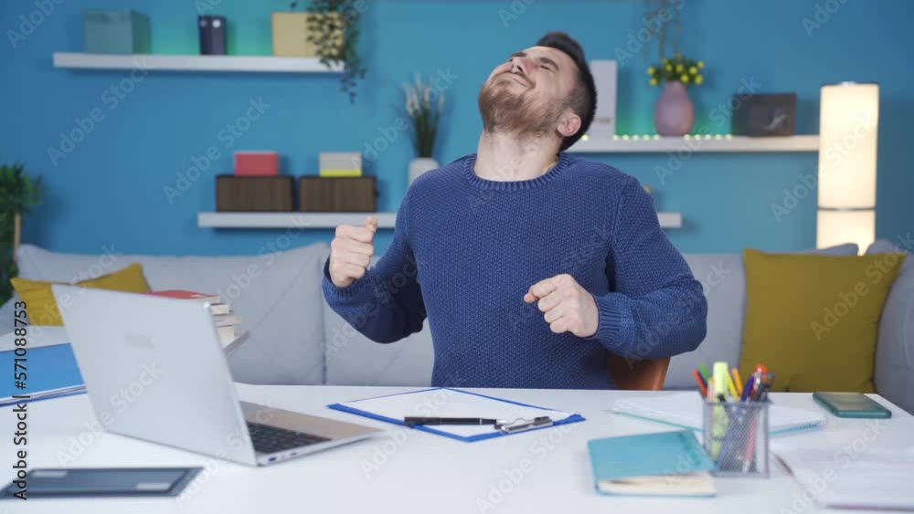 Young man working from home too much gets tired and his neck and back aches. It does neck and back exercises. Young man working from home too much gets tired and his neck and back aches. It does neck and back exercises.